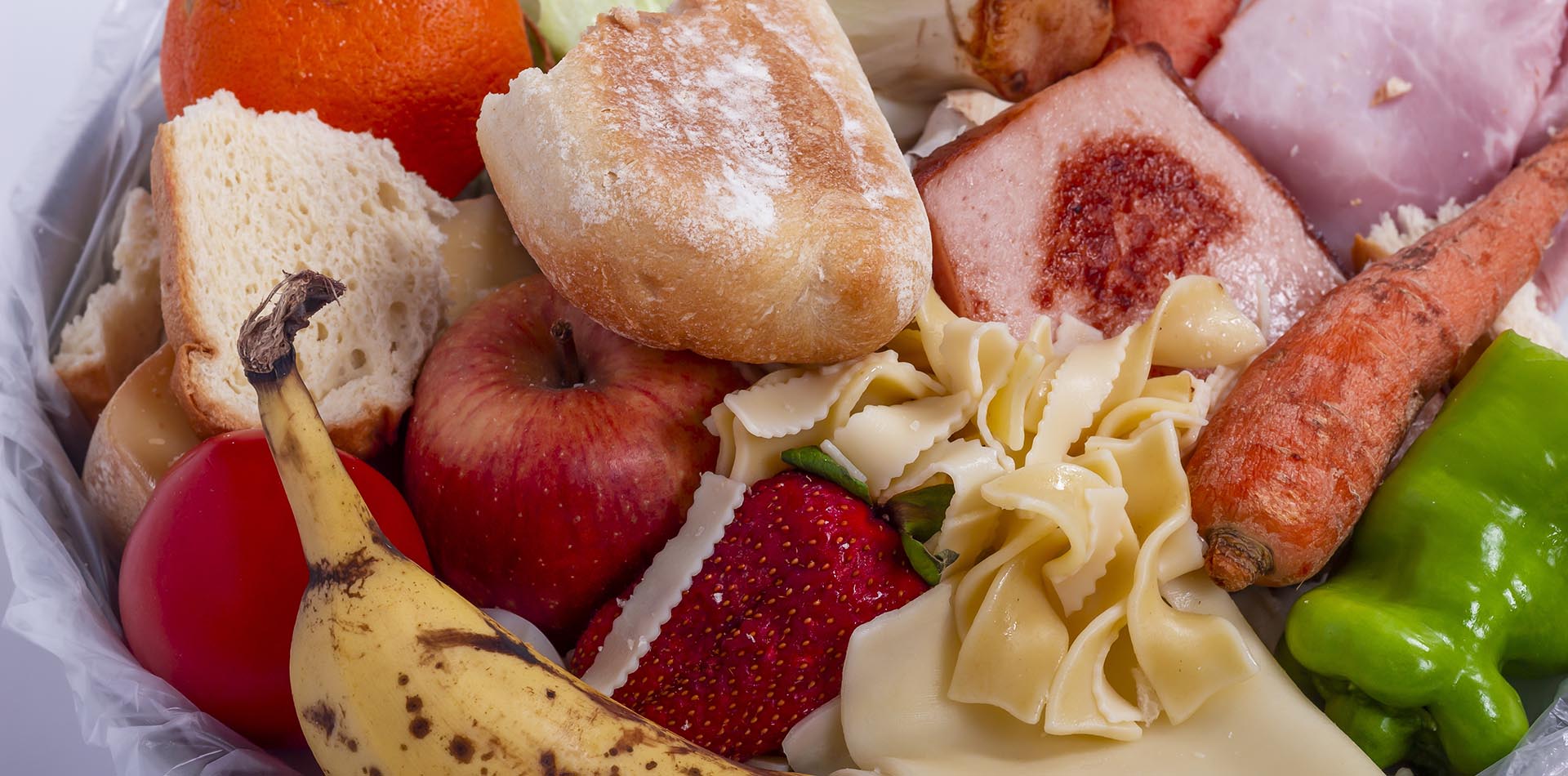 in einer Schüssel liegen Reste von Obst, Gemüse, Brot, Wurst und Nudeln